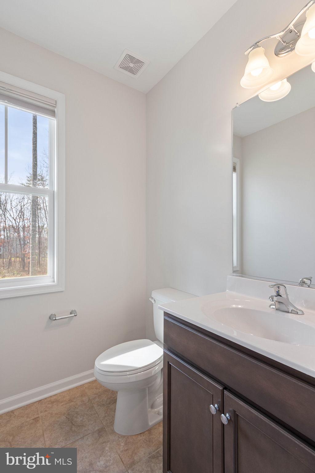 10602 Springvale Lane Spotsylvania, VA 22551 - Photo 26 of 92 a bathroom with a sink a toilet and a window