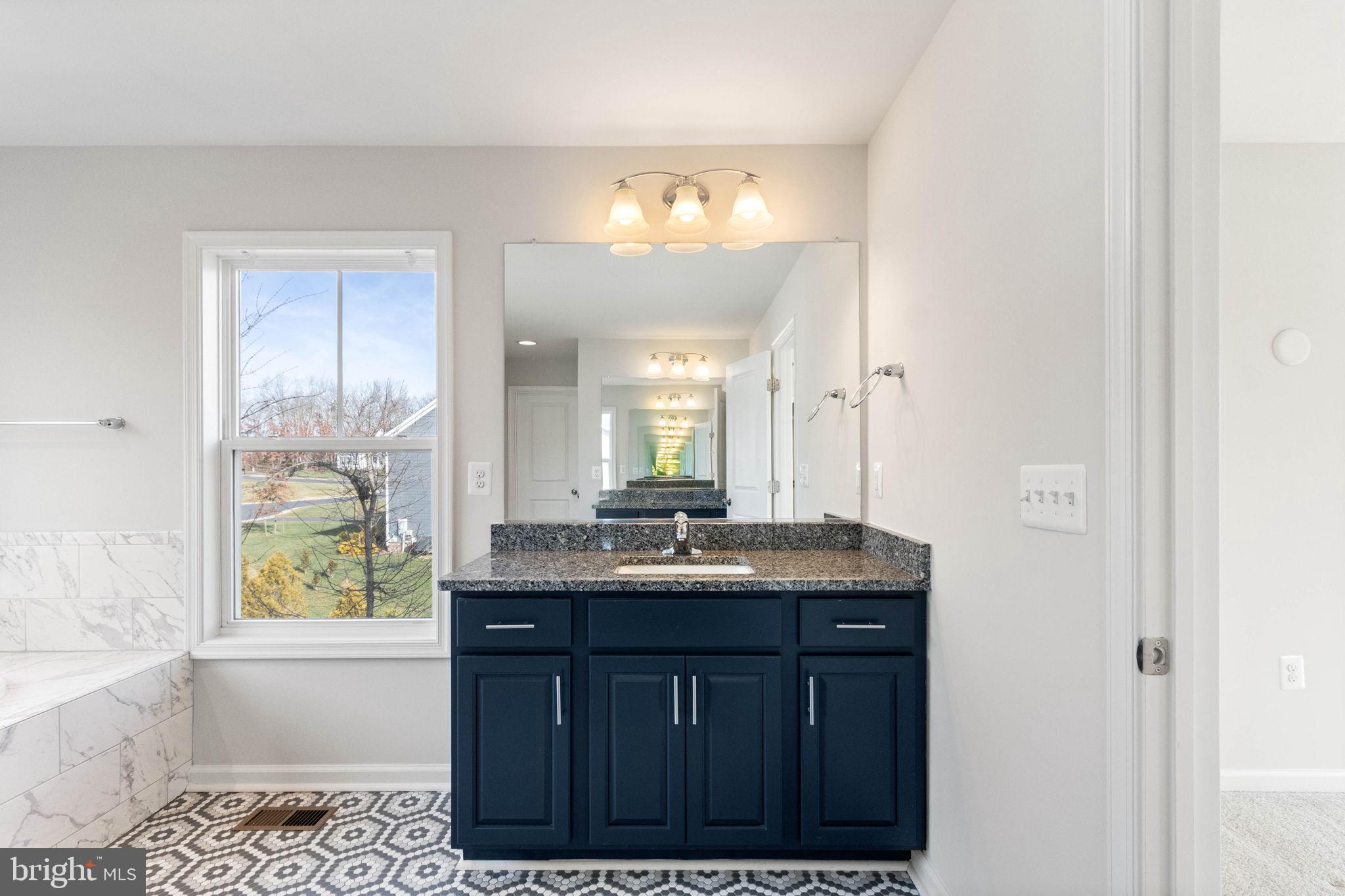 10602 Springvale Lane Spotsylvania, VA 22551 - Photo 34 of 92 a bathroom with a granite countertop sink a toilet and a bathtub