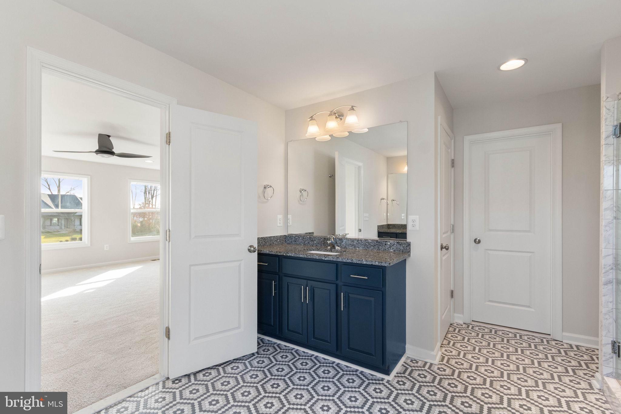 10602 Springvale Lane Spotsylvania, VA 22551 - Photo 36 of 92 a spacious bathroom with a granite countertop sink a mirror and a shower