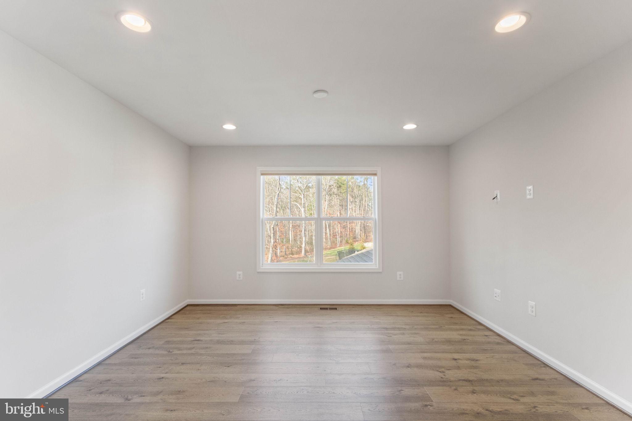 10602 Springvale Lane Spotsylvania, VA 22551 - Photo 47 of 92 an empty room with wooden floor and windows