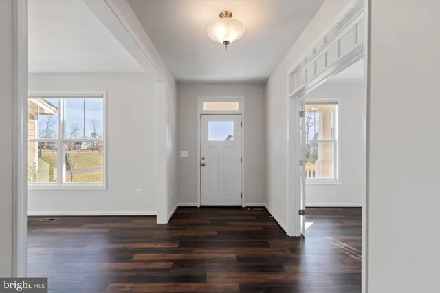 a dining room with furniture a chandelier and wooden floor