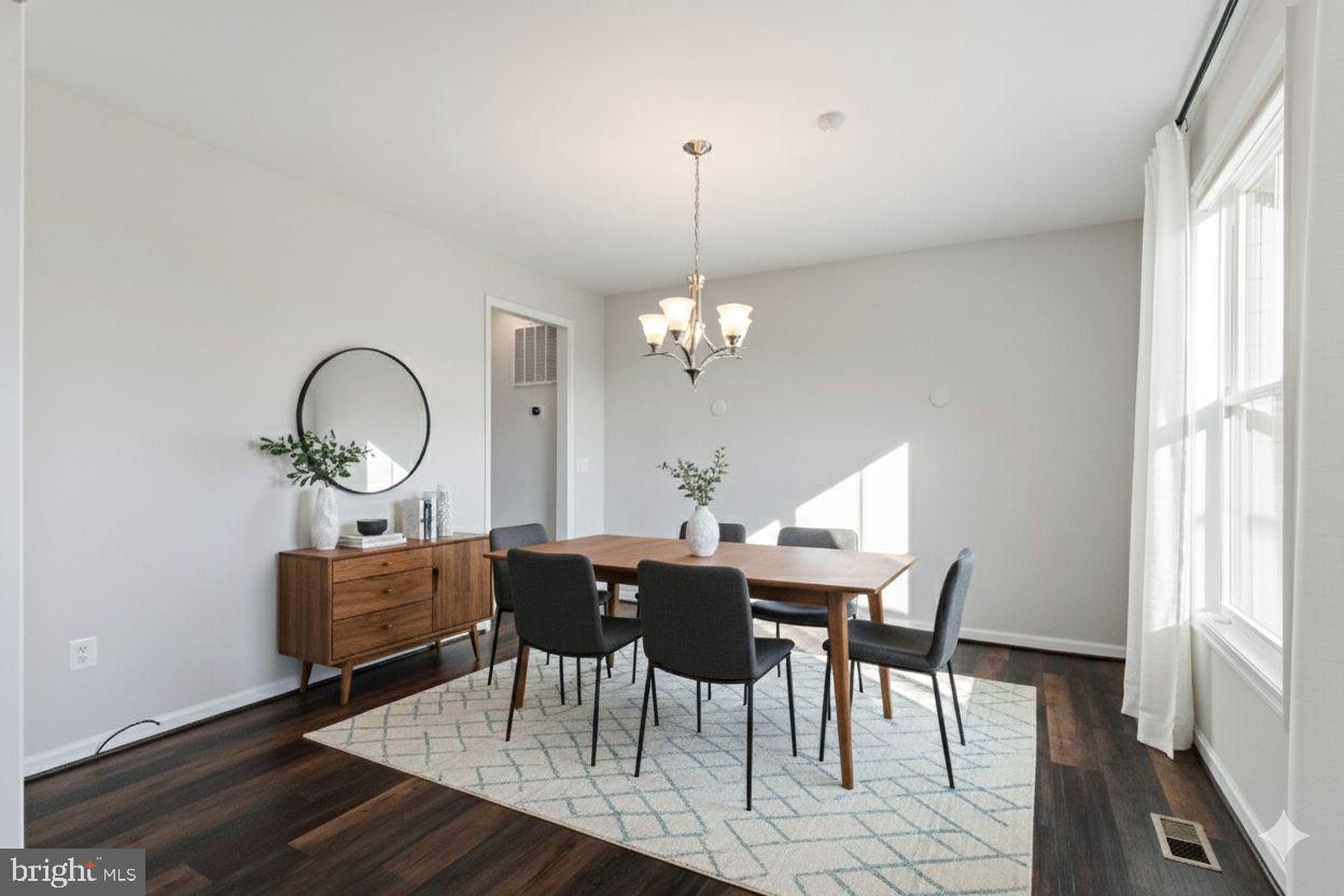 10602 Springvale Lane Spotsylvania, VA 22551 - Photo 10 of 92 a dining room with furniture a chandelier and wooden floor