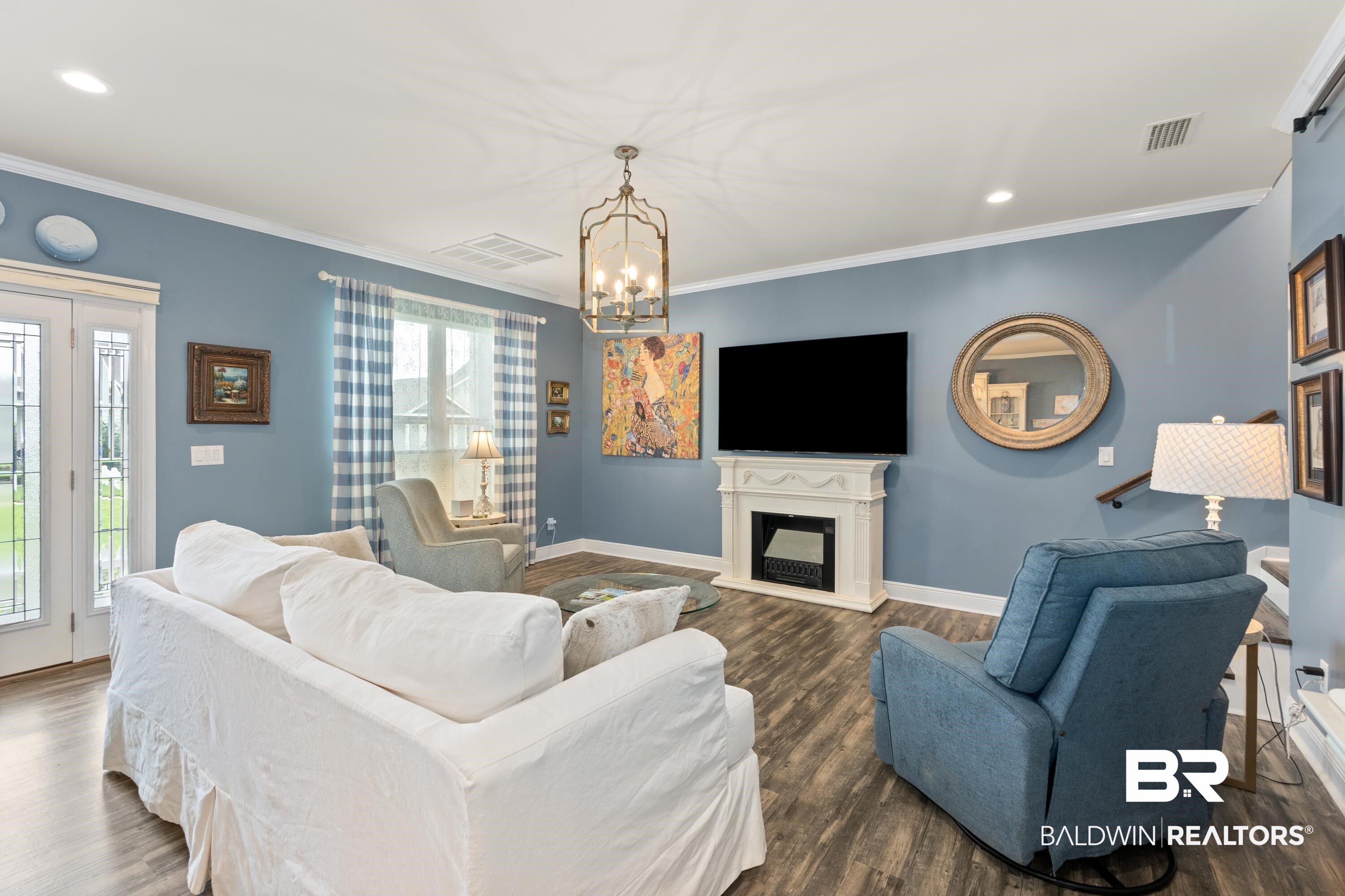 1113 Yellow Daisy Lane Foley, AL 36535 - Photo 7 of 35 Living room with a fireplace with raised hearth, crown molding, recessed lighting, dark wood finished floors, and a chandelier