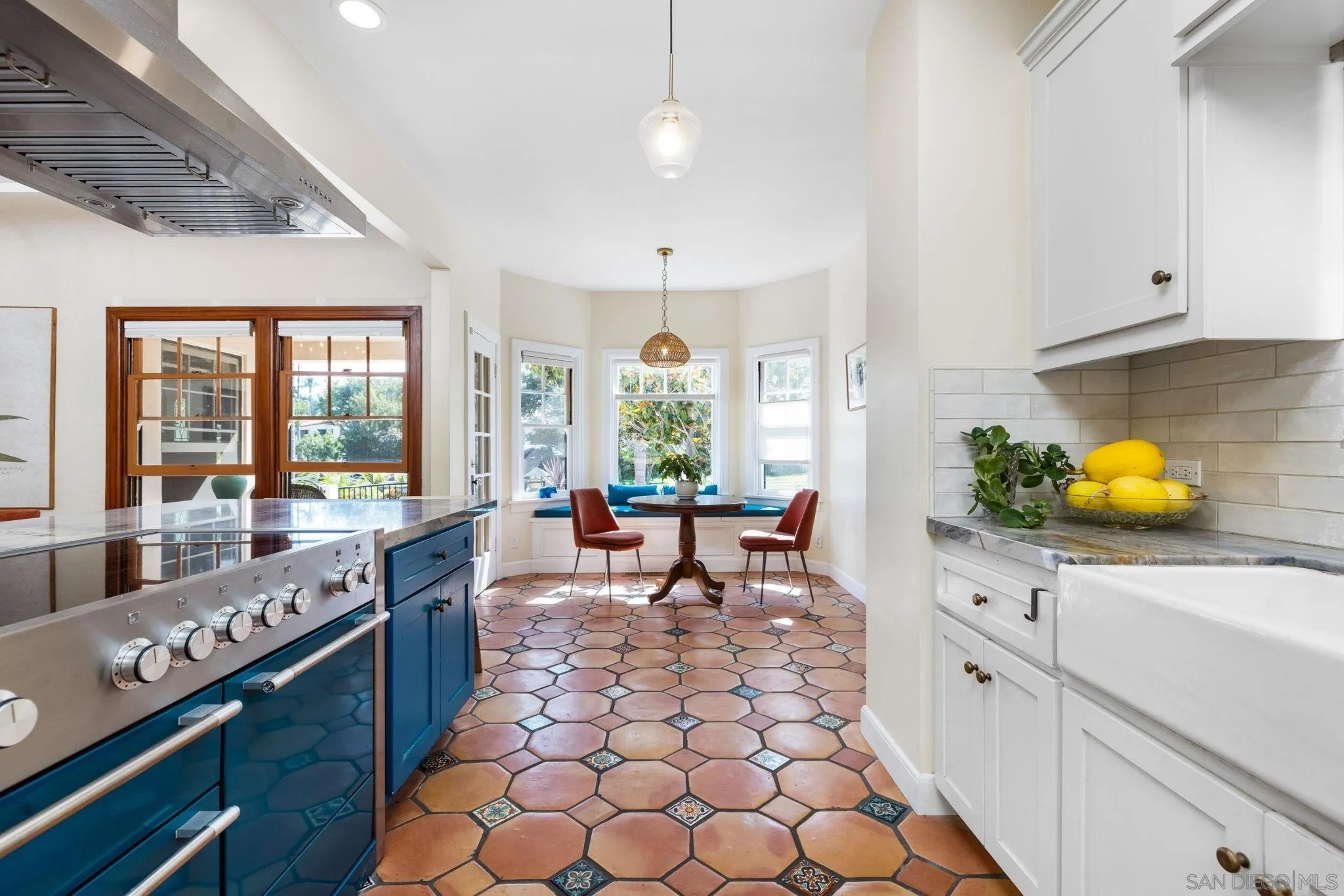 4192 Rochester Road San Diego, CA 92116 - Photo 2 of 38 a large white kitchen with lots of counter space and windows