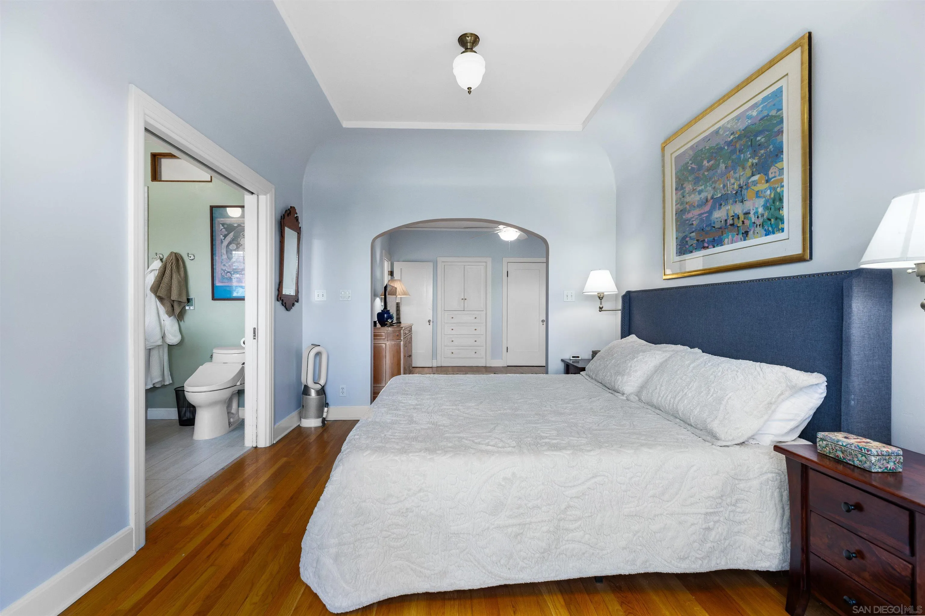 4192 Rochester Road San Diego, CA 92116 - Photo 24 of 38 a bedroom with a large bed and a chandelier