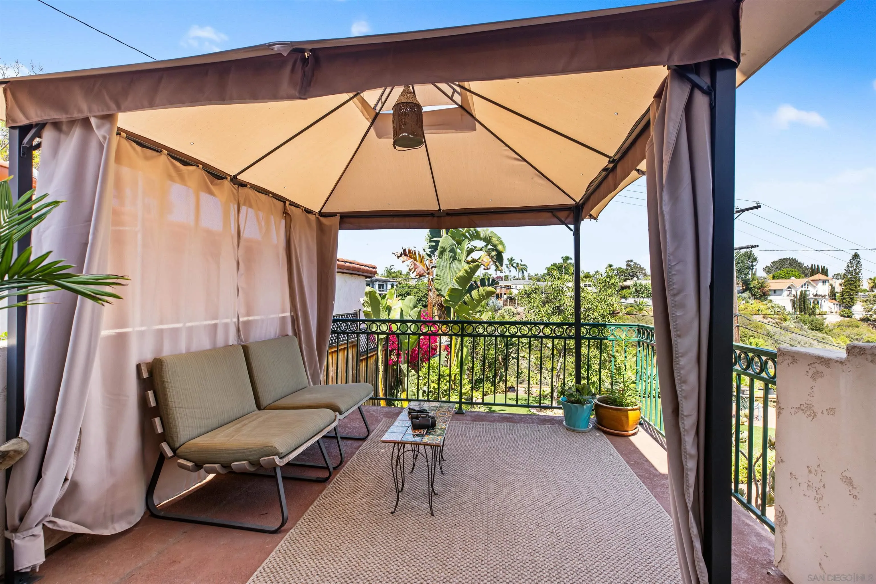 4192 Rochester Road San Diego, CA 92116 - Photo 25 of 38 a view of patio with a table and chairs under an umbrella