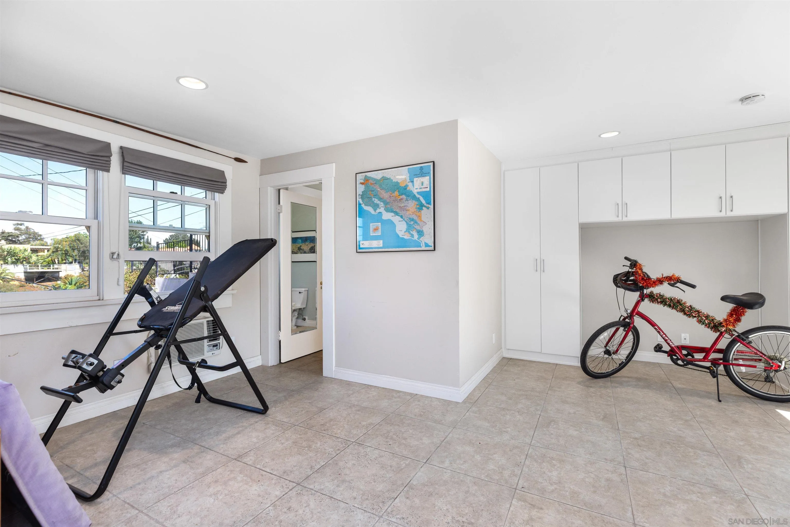 4192 Rochester Road San Diego, CA 92116 - Photo 28 of 38 a view of a room with gym equipment and windows