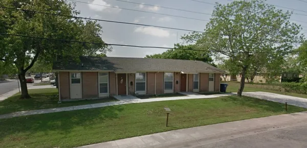 a view of a house with a yard and tree s