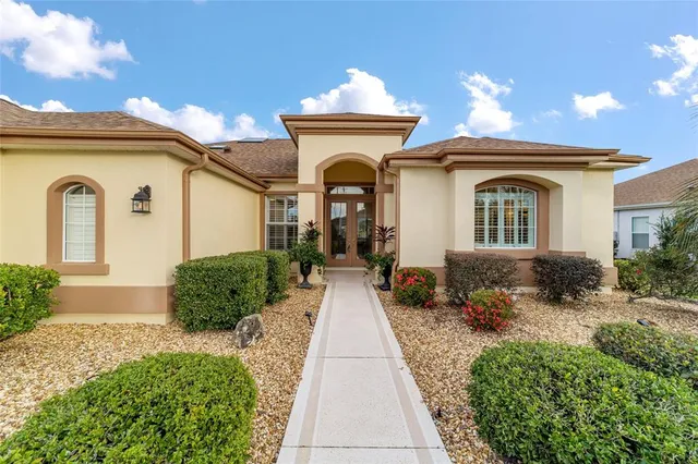 a front view of a house with a garden