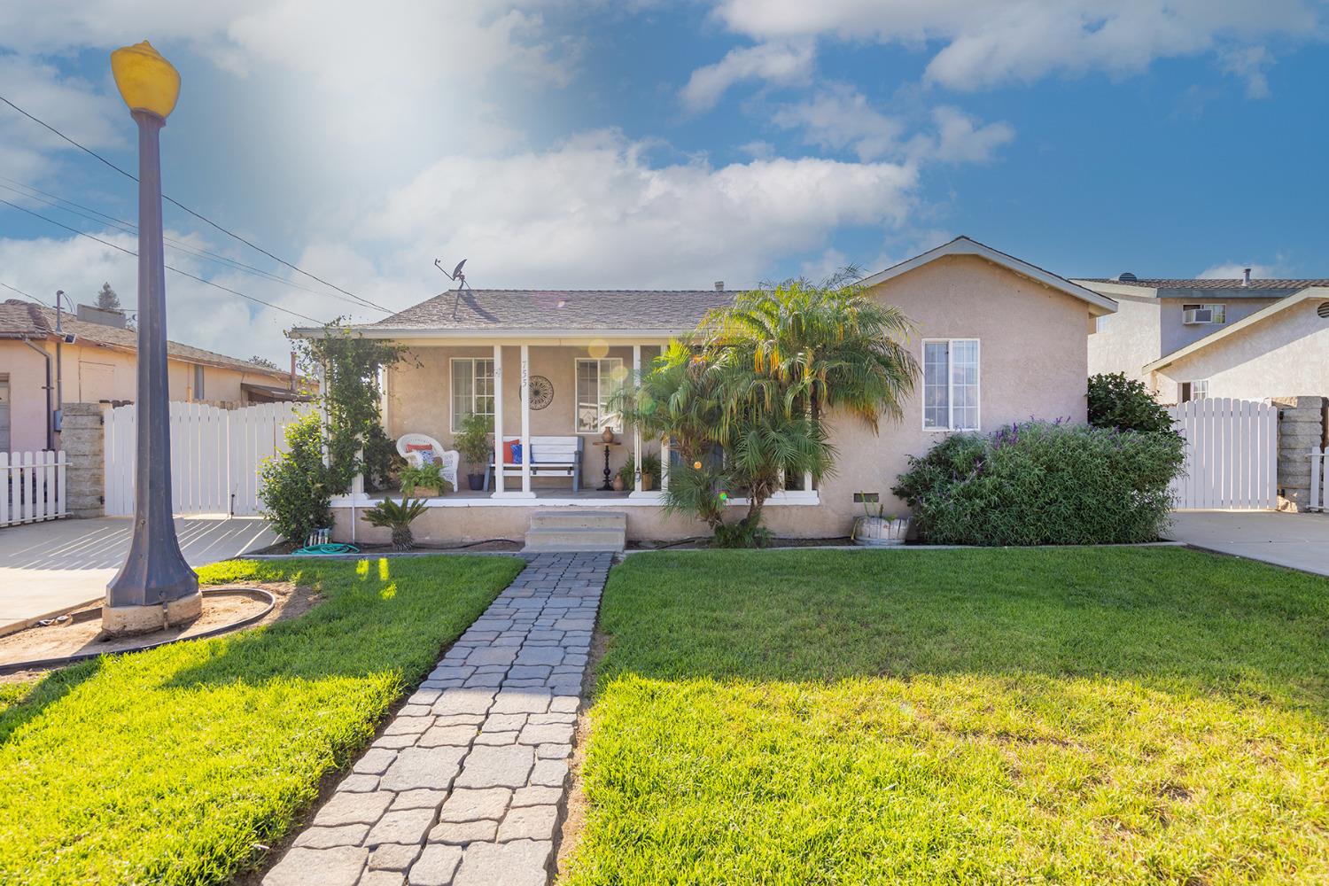 a view of a backyard with plants and a patio