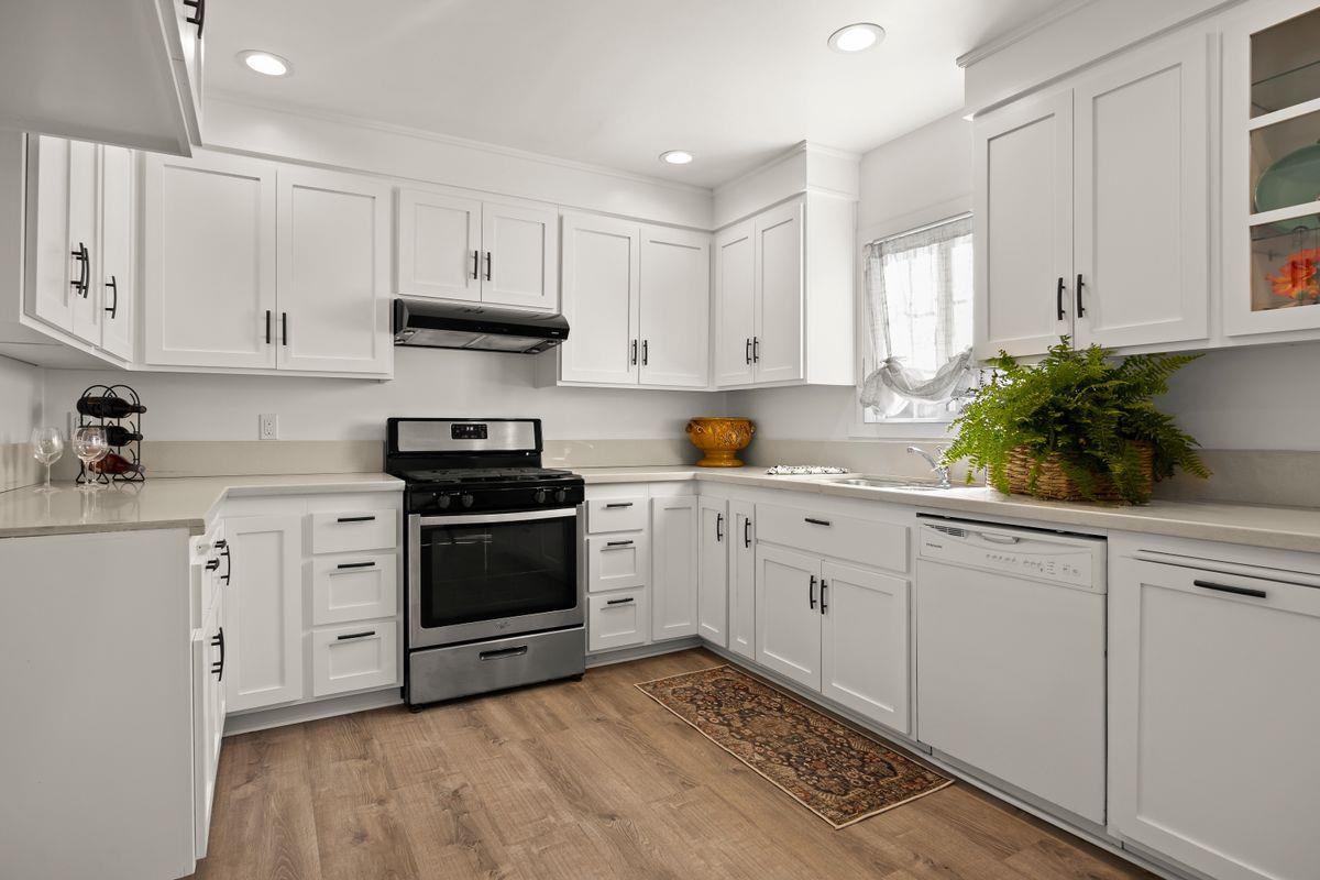 755 Spring Street Oak View, CA 93022 - Photo 11 of 29 a kitchen with white cabinets and white appliances