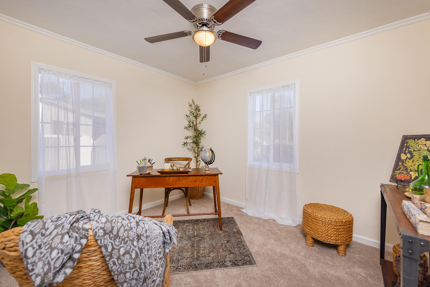 755 Spring Street Oak View, CA 93022 - Photo 15 of 29 a bedroom with a bed and a chandelier fan