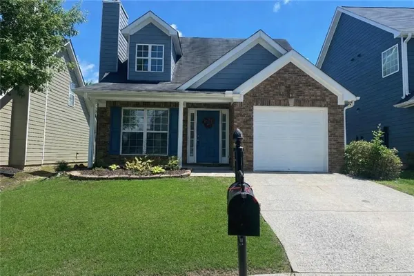 a front view of a house with a yard
