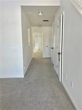 6475 White Walnut Way Braselton, GA 30517 - Photo 13 of 32 a view of a hallway with wooden shelves