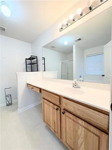 a bathroom with a sink double vanity and a mirror
