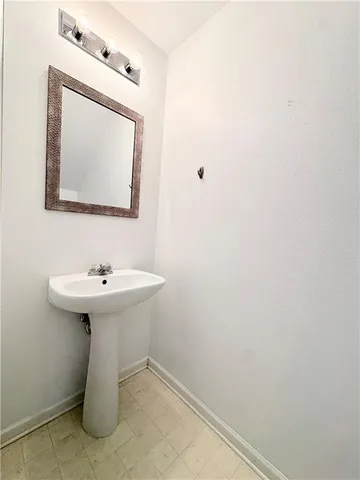 a bathroom with a sink a mirror and toilet