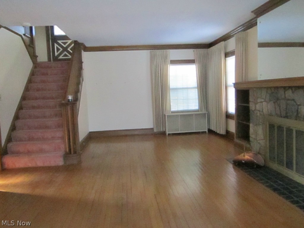 233 East Schaaf Road Independence, OH 44131 - Photo 4 of 22 The huge, gracious living room offers a woodburning/gas fireplace. The beautiful staircase leads up to the terrace level enclosed and glassed-in patio.