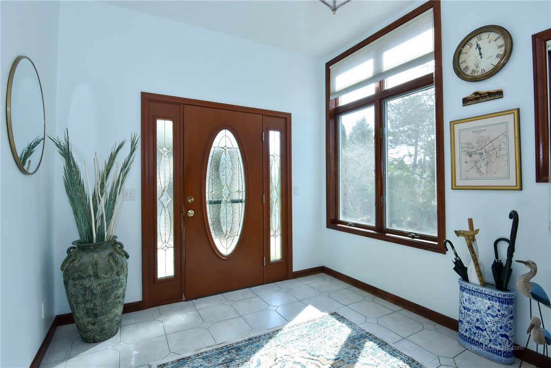 20 Grey Gull Road Jamestown, RI 02835 - Photo 3 of 40 Sun filled Entry Foyer with lots of closet space and access to the 3 car garage! This room is 11' x 9'.