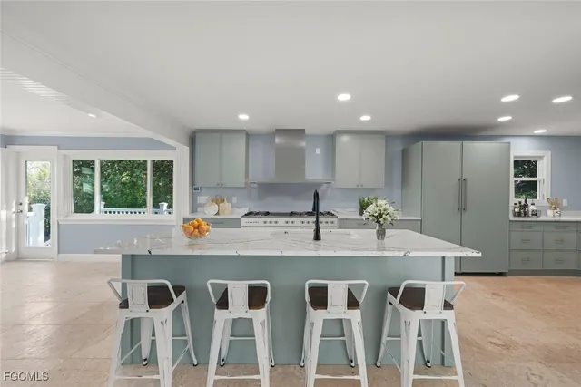 a kitchen with stainless steel appliances granite countertop a sink and a refrigerator