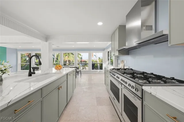 a kitchen with stainless steel appliances a sink a stove and cabinets