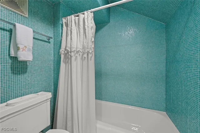 a bathroom with a shower and a toilet