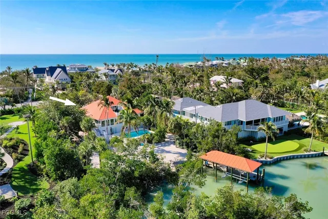 an aerial view of a house with a garden and lake view