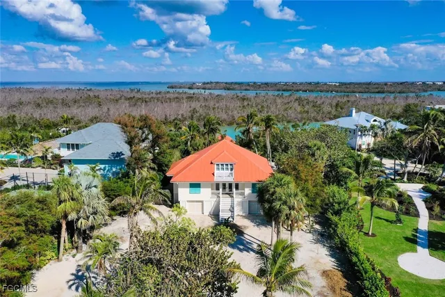 an aerial view of a house with a lake view