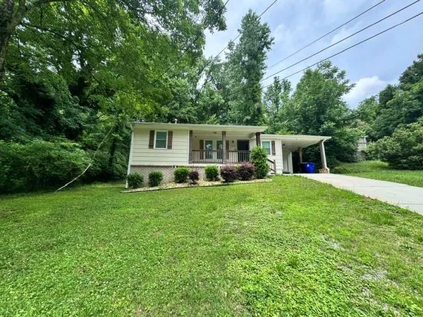 a front view of house with yard and green space