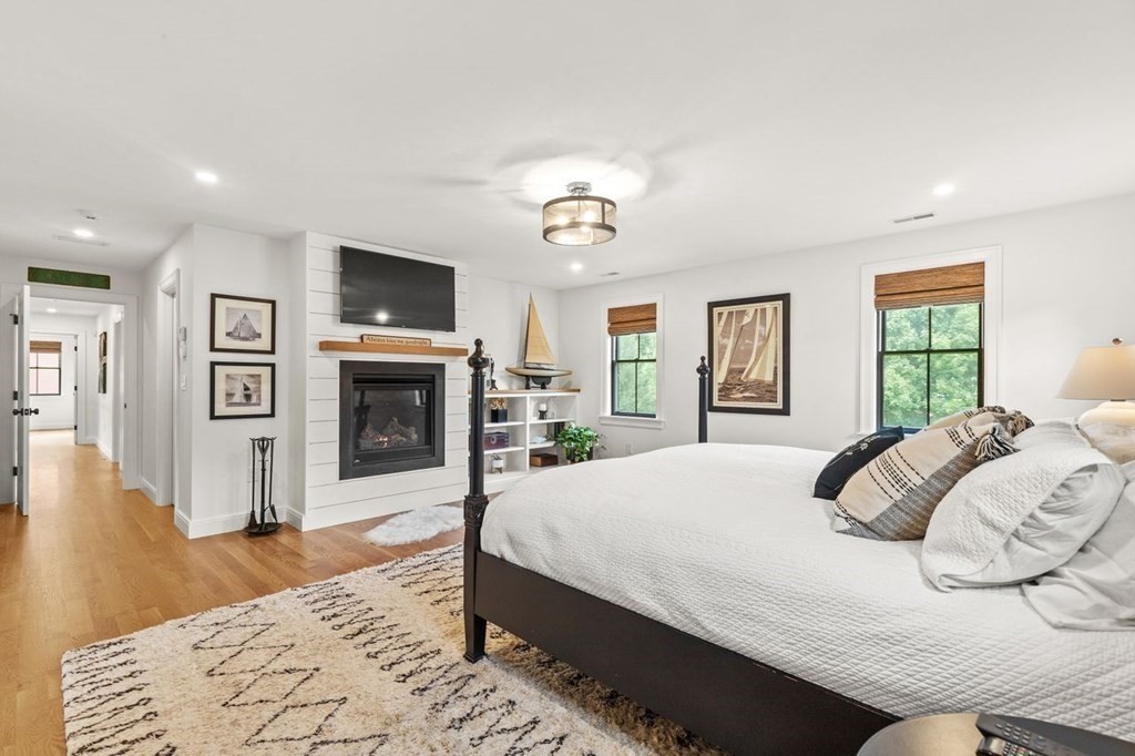 231 Marrett Road Lexington, MA 02421 - Photo 12 of 24 a bedroom with a bed and a flat screen tv