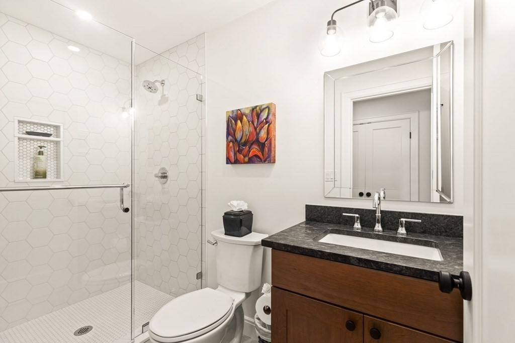 231 Marrett Road Lexington, MA 02421 - Photo 16 of 24 a bathroom with a sink toilet and shower