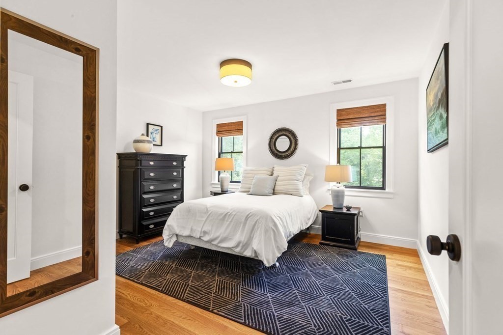 231 Marrett Road Lexington, MA 02421 - Photo 18 of 24 a bedroom with a bed and a window
