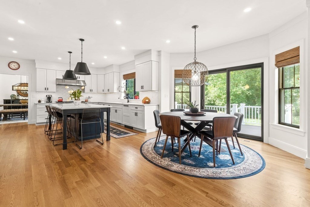 231 Marrett Road Lexington, MA 02421 - Photo 7 of 24 a dining room with furniture a chandelier and wooden floor