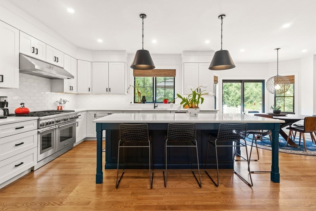 231 Marrett Road Lexington, MA 02421 - Photo 8 of 24 a kitchen with stainless steel appliances granite countertop a stove a sink and a wooden floors