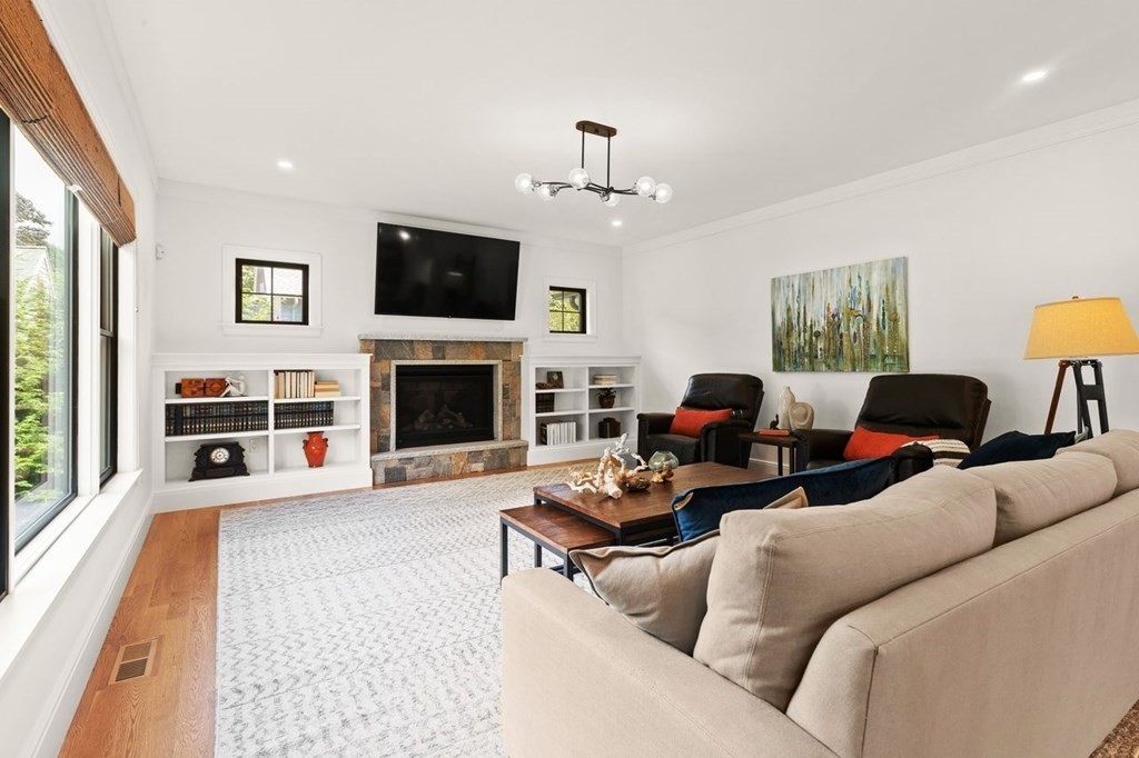 231 Marrett Road Lexington, MA 02421 - Photo 10 of 24 a living room with furniture a flat screen tv and a fireplace