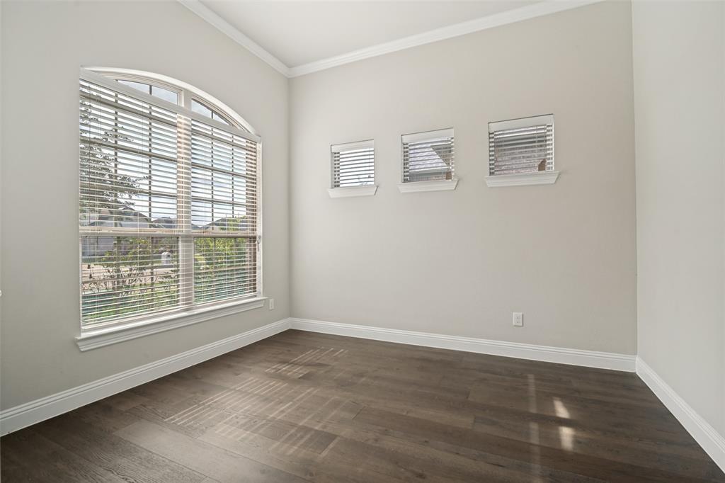 2802 Merlot Circle Rowlett, TX 75088 - Photo 5 of 40 a view of an empty room with wooden floor and a window