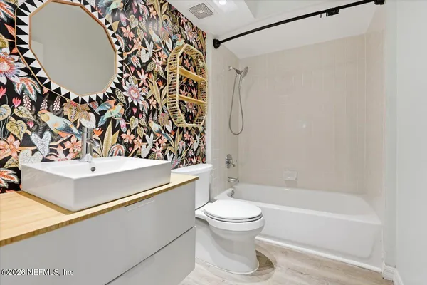 a bathroom with a toilet and a shower curtain