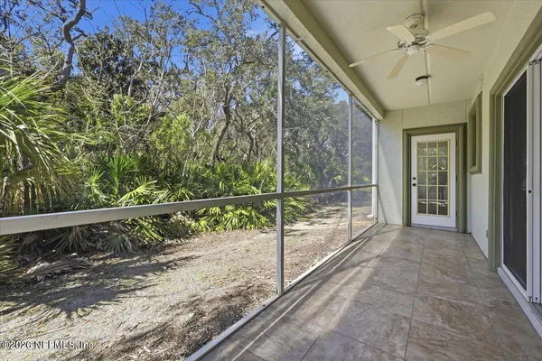 a view of a balcony with floor to ceiling windows and wooden fence