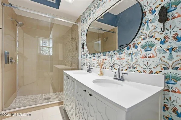 a bathroom with a sink mirror and vanity