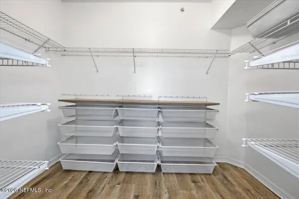 a view of walk in closet with empty racks