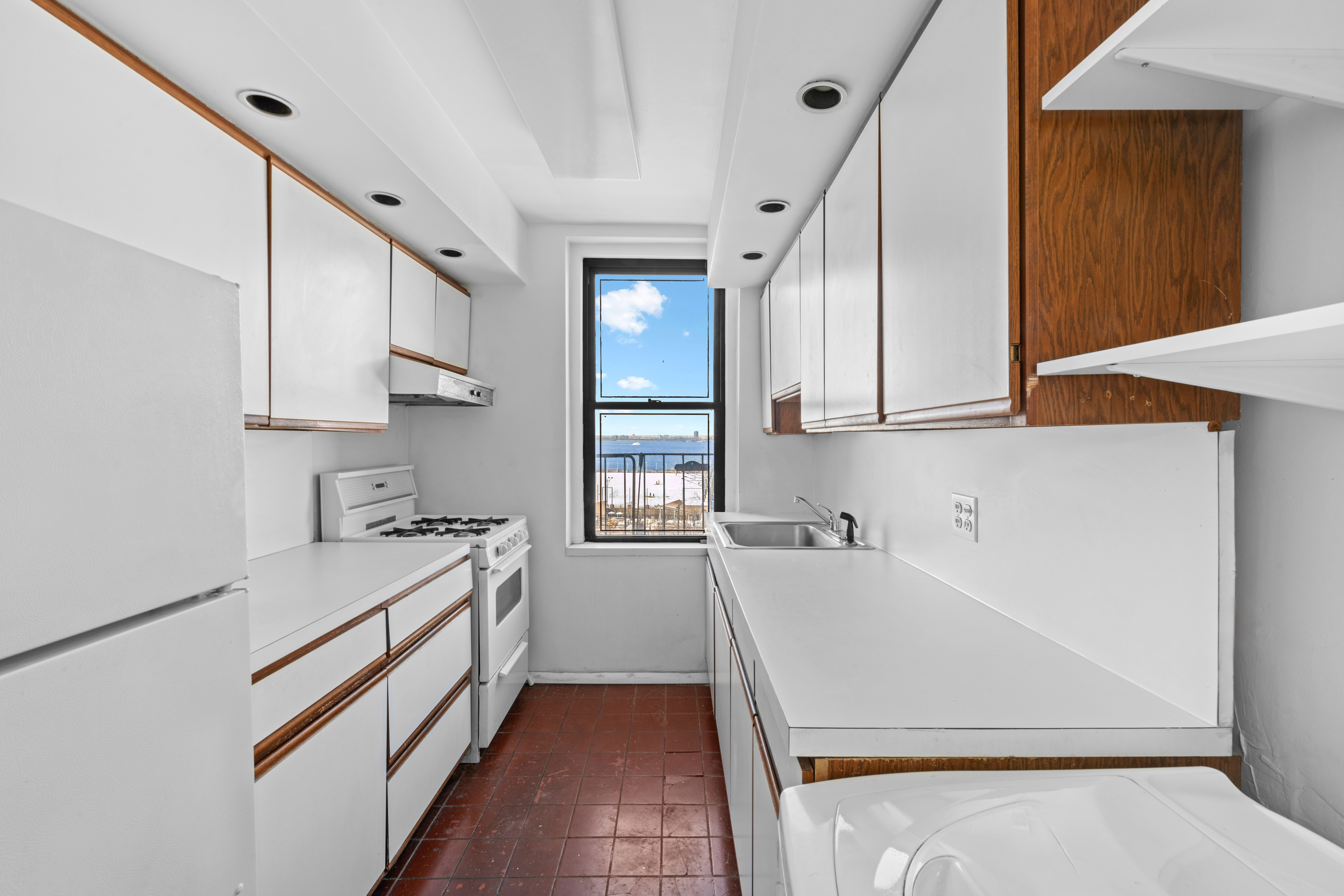 2 Grace Court, Unit 3X Brooklyn, NY 11201 - Photo 5 of 8 a kitchen with a sink a stove and cabinets