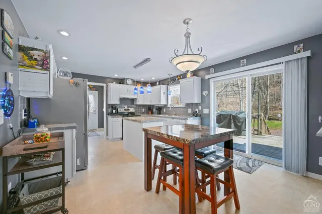 a living room with furniture and a large mirror