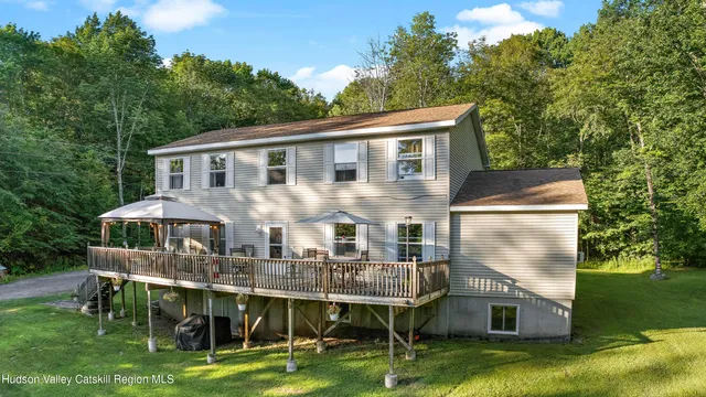 a backyard of a house with table and chairs