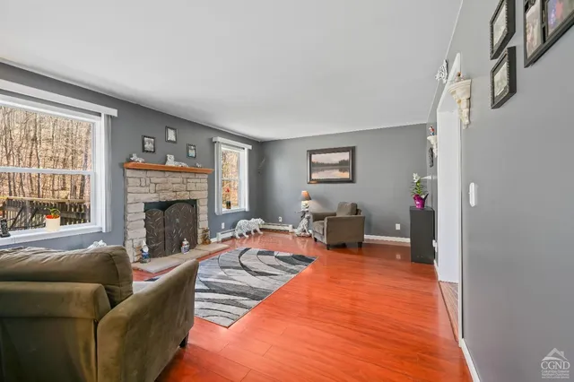 a view of a house with a small yard and sitting area