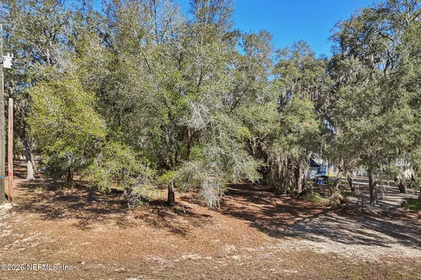 a view of a field with trees in the background