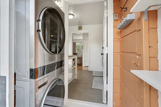 a view of a back yard with flower plants and wooden fence