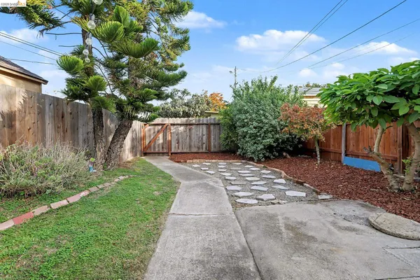 a view of backyard with a garden and deck