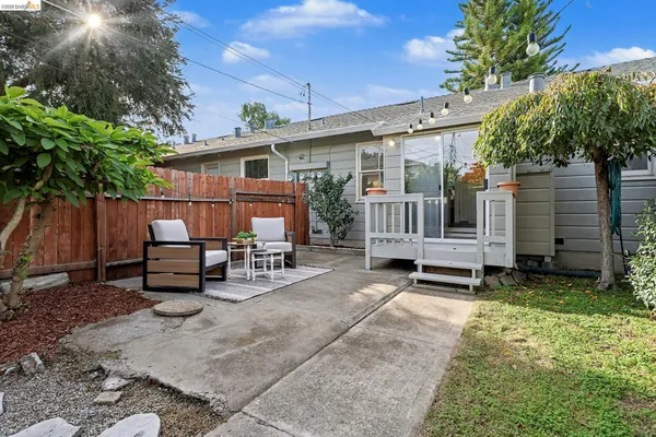a backyard of a house with yard and outdoor seating