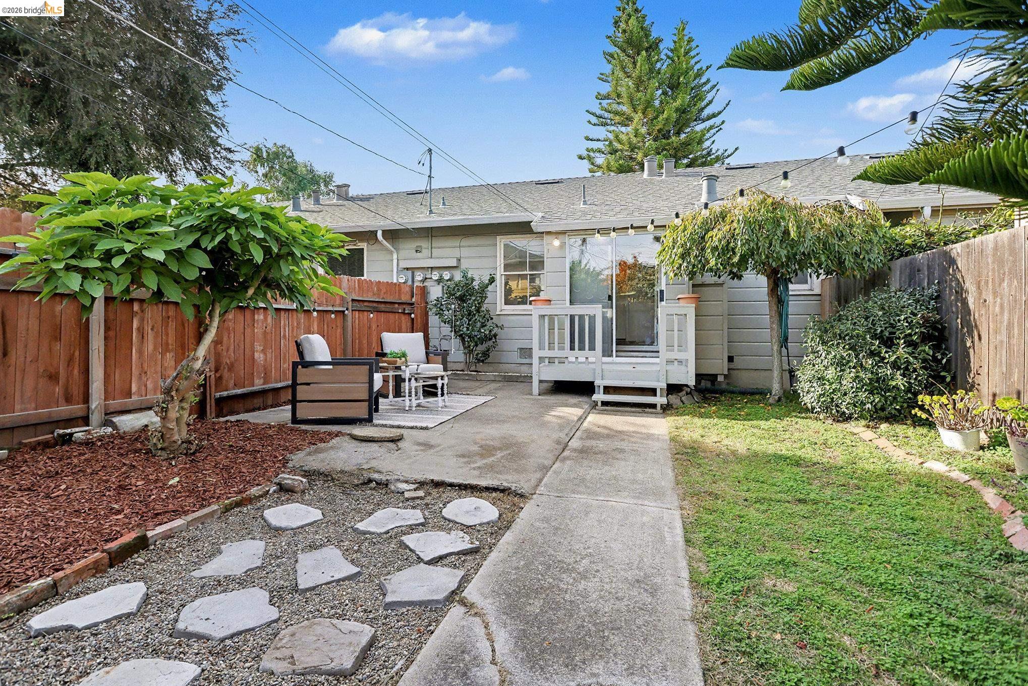 1808 Main Street Alameda, CA 94501 - Photo 17 of 18 Back of house featuring a fenced backyard, a shingled roof, a patio area, and a deck