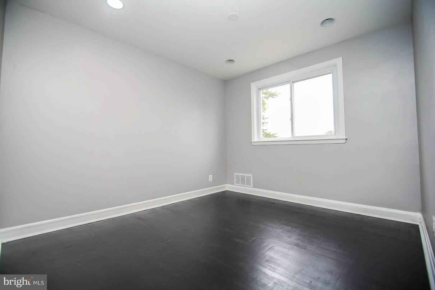 1962 Church Road Baltimore, MD 21222 - Photo 14 of 23 an empty room with wooden floor and windows