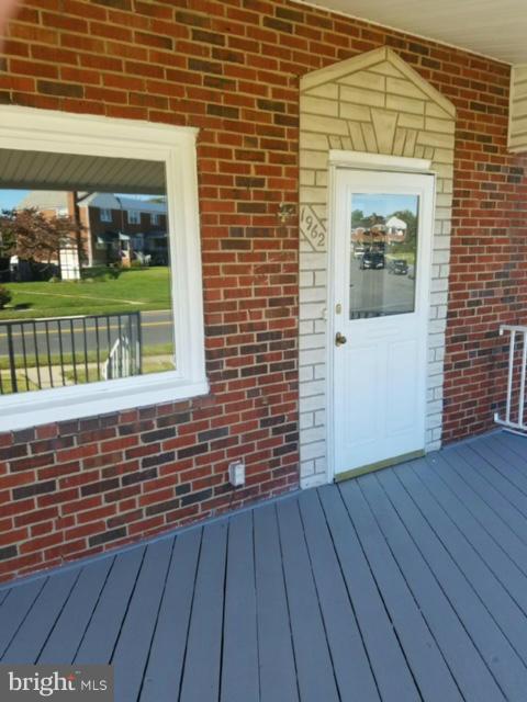 1962 Church Road Baltimore, MD 21222 - Photo 3 of 23 a view of front door of house with wooden floor